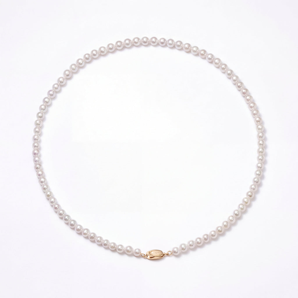 Pearl necklace with a gold clasp on a white background