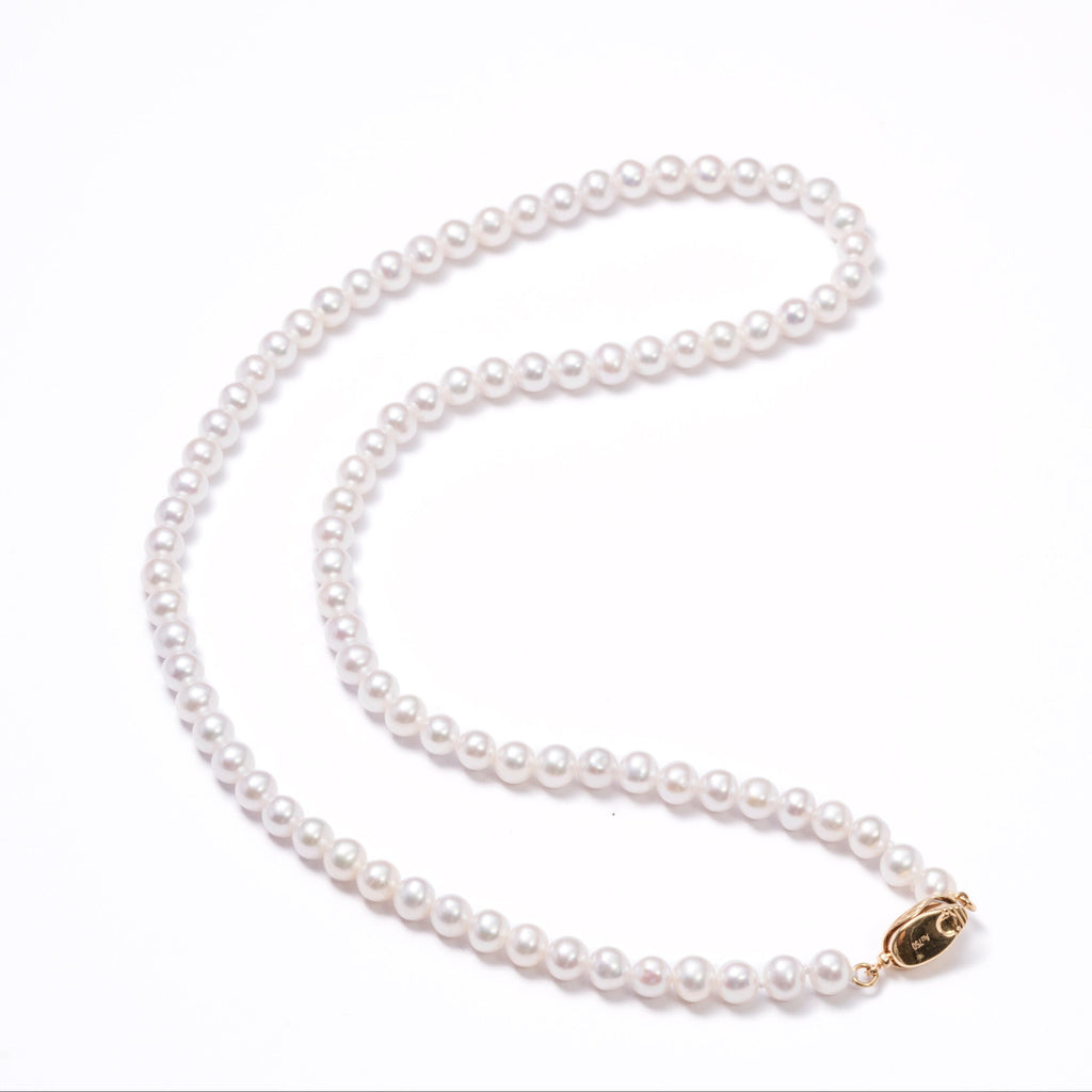 Pearl necklace with a gold clasp on a white background