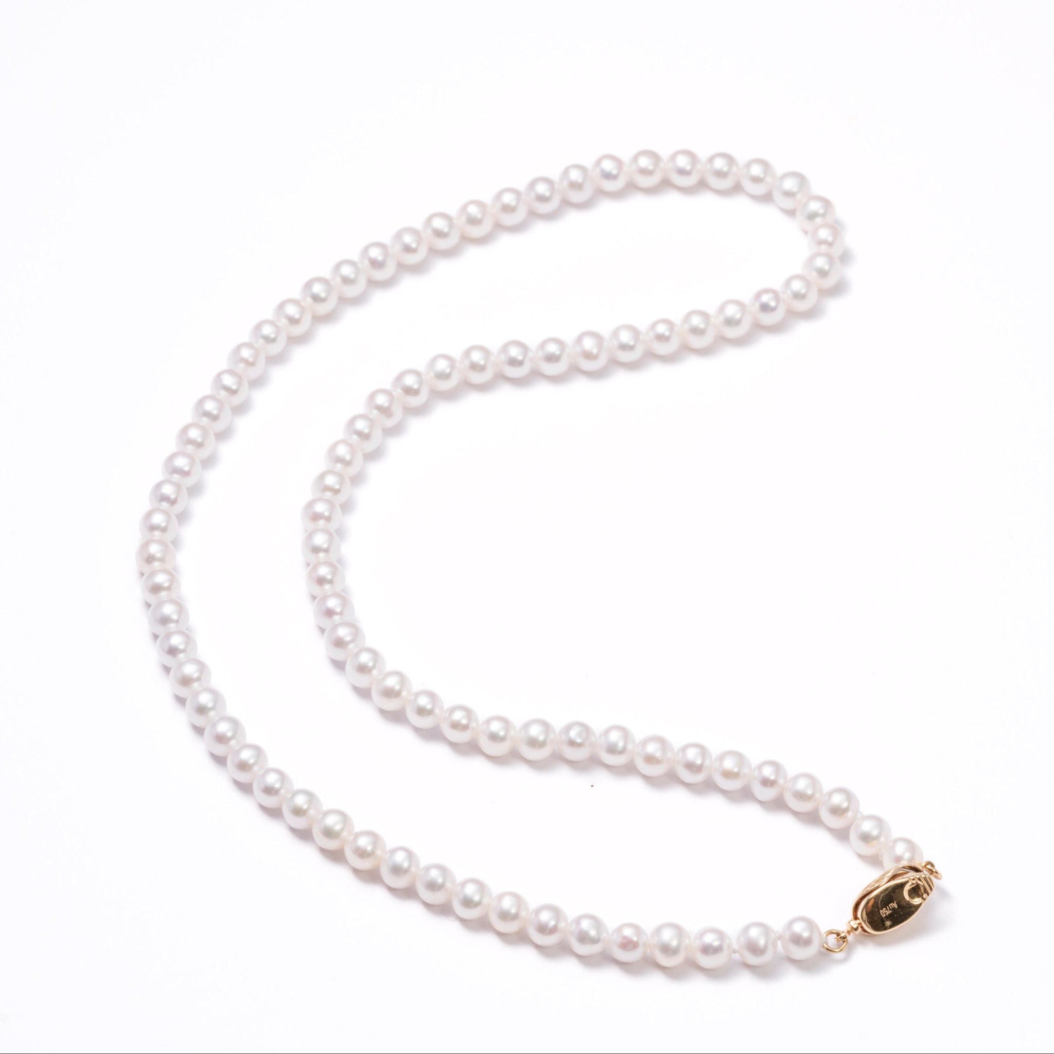Pearl necklace with a gold clasp on a white background